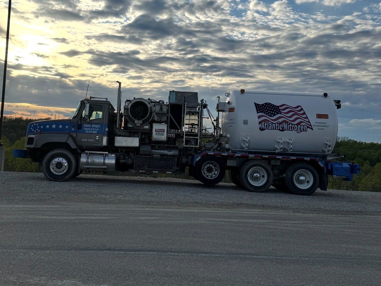 Cryogenic nitrogen pumper truck in profile under an evening sky