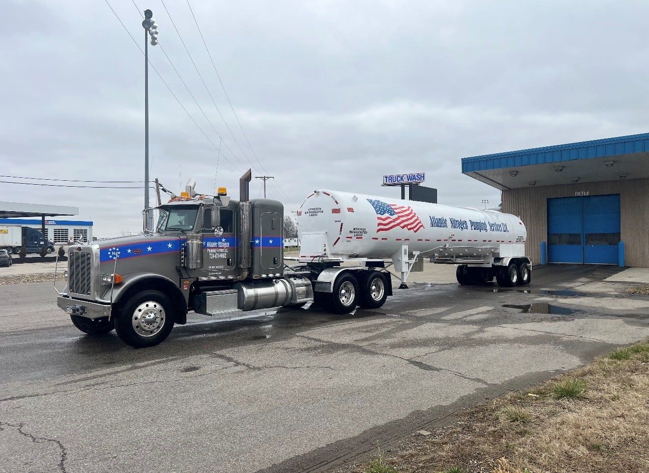 Atlantic Nitrogen Pumping Services cryogenic transport and tractor on a wet lot